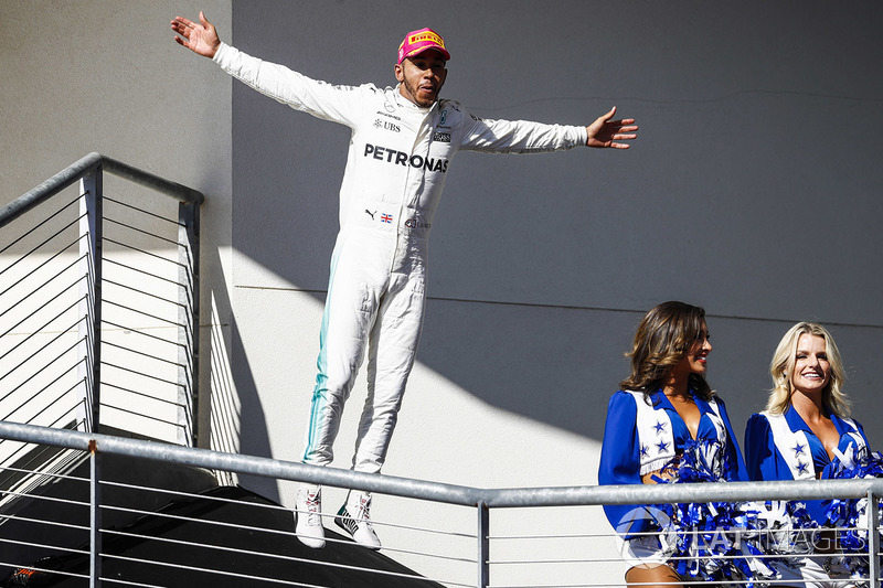 Race winner Lewis Hamilton, Mercedes AMG F1, jumps as he celebrates on the podium