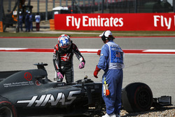 Romain Grosjean, Haas VF-17, climbs from his car after spinning