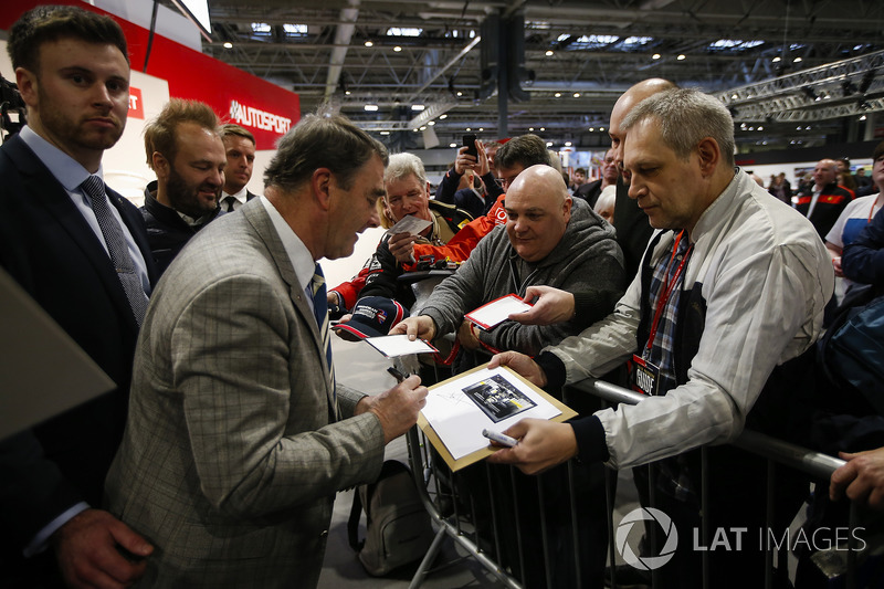 Nigel Mansell signs autographs for fans