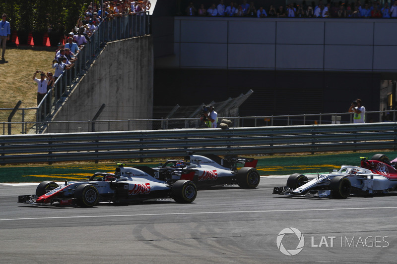 Kevin Magnussen, Haas F1 Team VF-18, leads Romain Grosjean, Haas F1 Team VF-18, and Charles Leclerc, Sauber C37