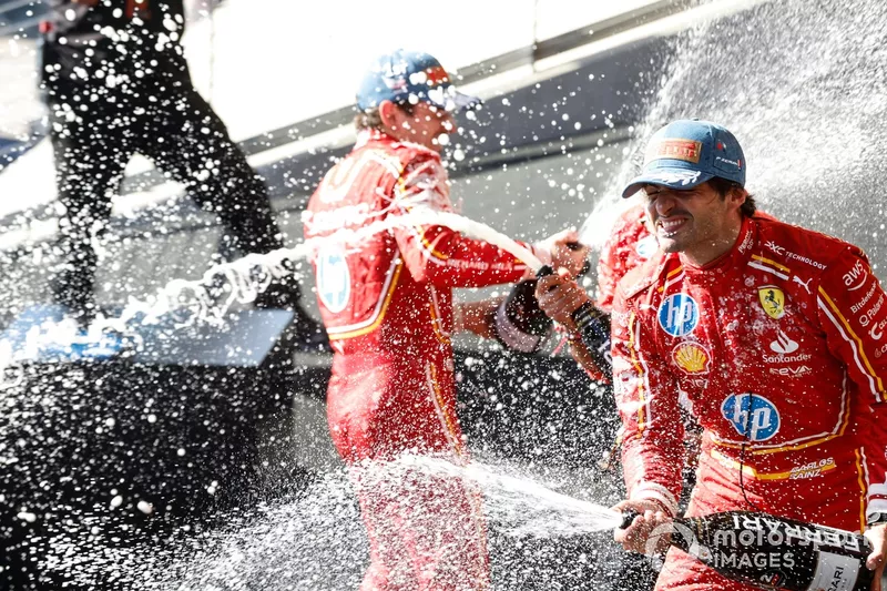 Charles Leclerc, Scuderia Ferrari, 1st position, Carlos Sainz, Scuderia Ferrari, 2nd position, celebrate on the podium with Champagne