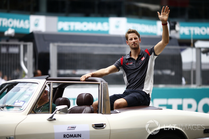 Romain Grosjean, Haas F1 Team VF-17, waves from a Triump Stag on the drivers parade