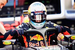 Daniel Ricciardo, Red Bull Racing RB13, climbs into his cockpit, fitted, a halo