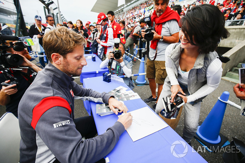 Romain Grosjean, Haas F1 Team, signs an autograph