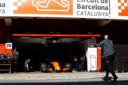 The McLaren garage door is raised as Fernando Alonso, McLaren MCL32 enters the pit lane