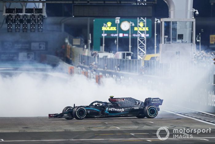 Lewis Hamilton, Mercedes F1 W11, 3ª posición, y Valtteri Bottas, Mercedes F1 W11, 2ª posición, realizan donuts de celebración en la parrilla después de la carrera.