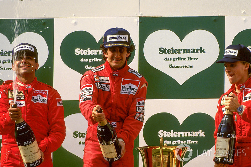 Podium: race winner Alain Prost, McLaren, second place Michele Alboreto, Ferrari, third place Stefan