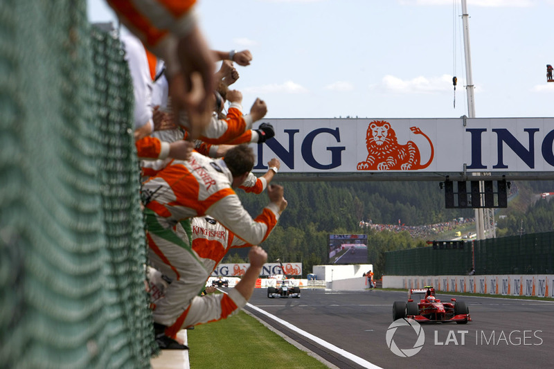 Kimi Raikkonen, Ferrari F60 crosses the line to win the race as the Force India team cheer Giancarlo Fisichella, Force India VJM02 Mercedes in second place