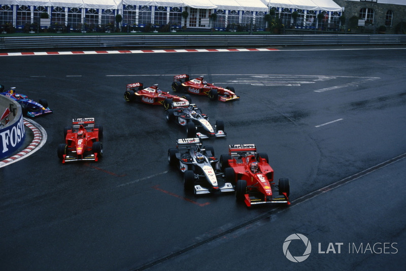 Michael Schumacher, Ferrari F300, collides with Mika Hakkinen, McLaren MP4/13 at the start