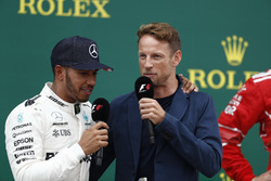 Race winner Lewis Hamilton, Mercedes AMG F1, is interviewed by Jenson Button, McLaren, on the podium