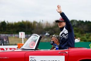 Yuki Tsunoda, Scuderia AlphaTauri, waves to the crowd on the drivers' parade