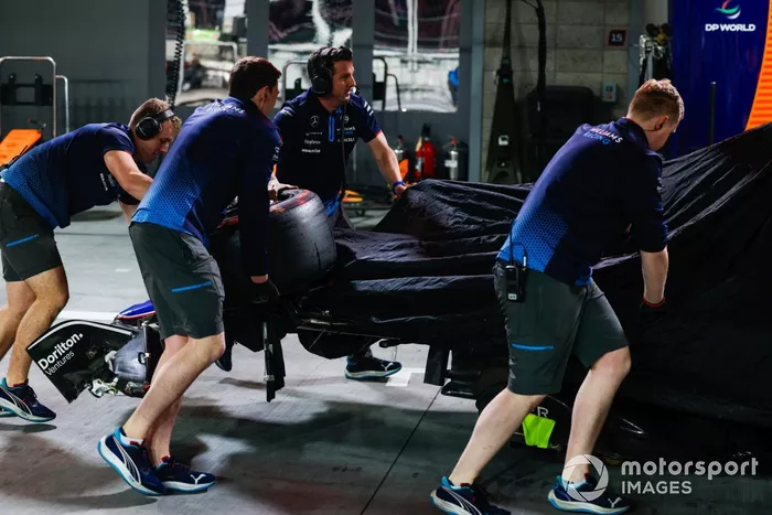 Los mecánicos traen los restos del coche de Franco Colapinto, Williams FW46