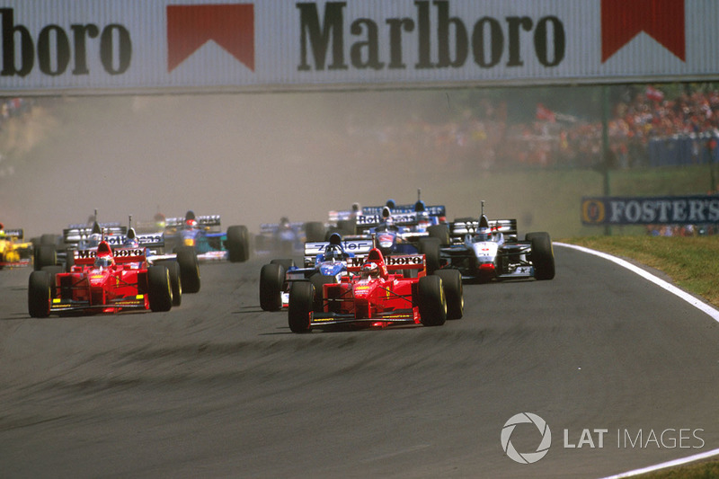 Michael Schumacher, Ferrari F310B, Damon Hill Arrows A18 Yamaha and Eddie Irvine, Ferrari F310B