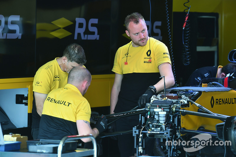 Renault Sport F1 Team mechanics work on Renault Sport F1 Team RS17 front wheel hub