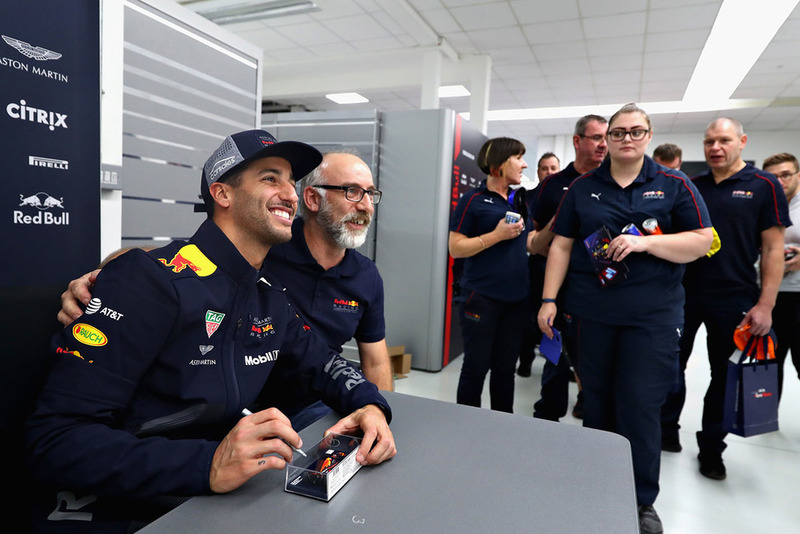 Daniel Ricciardo, Red Bull Racing poses for a photo with a Red Bull Racing team member