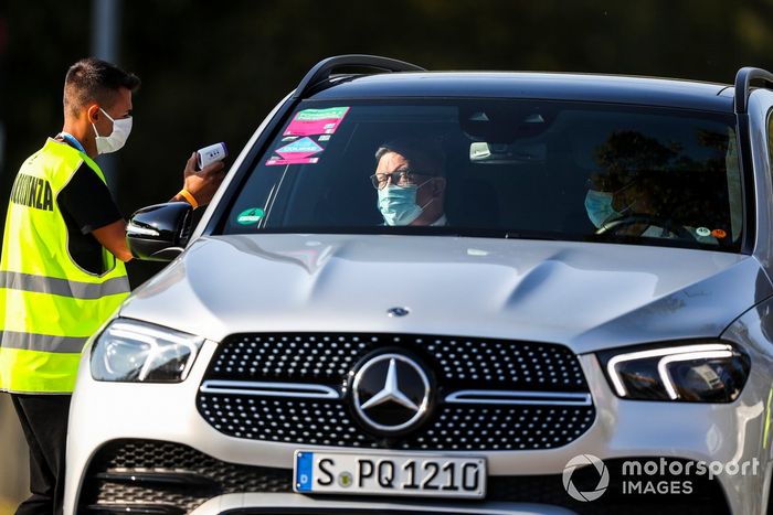 Ross Brawn, Managing Director of Motorsports, FOM gets heat checked on his way into the circuit