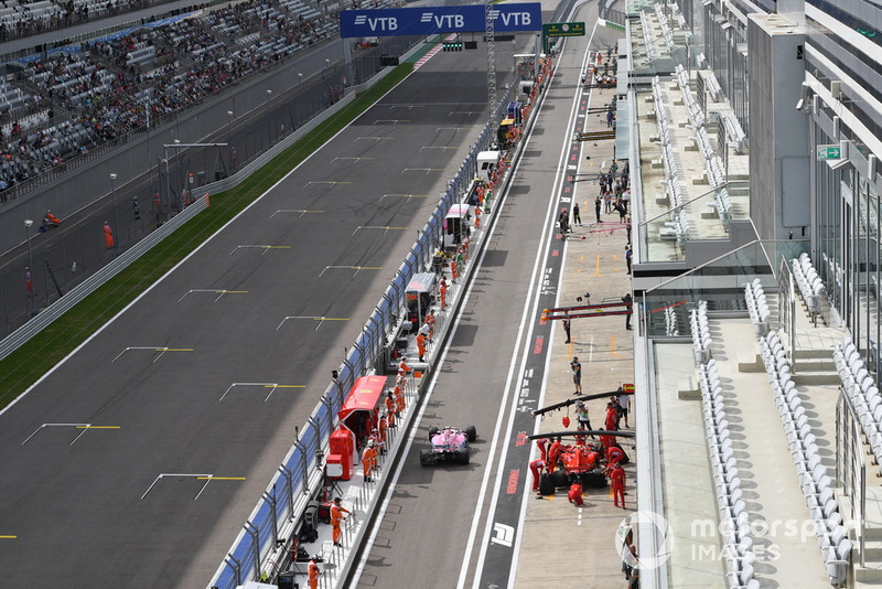Esteban Ocon, Racing Point Force India VJM11 y Kimi Raikkonen, Ferrari SF71H en el pit lane