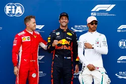 Daniel Ricciardo, Red Bull Racing, celebrates pole position between Sebastian Vettel, Ferrari, and Lewis Hamilton, Mercedes AMG F1