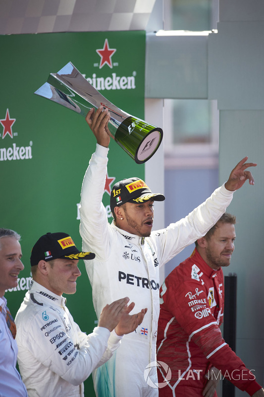 Second place Valtteri Bottas, Mercedes AMG F1, applauds as Race winner Lewis Hamilton, Mercedes AMG F1, raises the winners trophy
