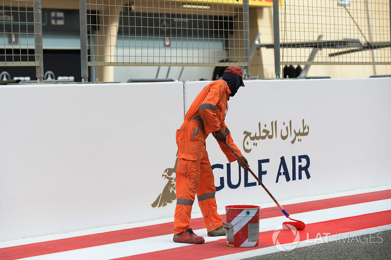 Worker paints the track