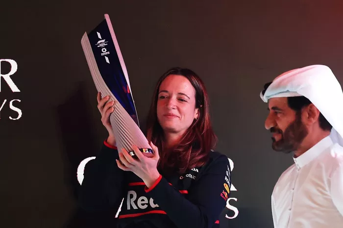 Hannah Schmitz, Principal Strategy Engineer of Oracle Red Bull Racing collects the Constructors trophy on the podium during the F1 Grand Prix of Qatar