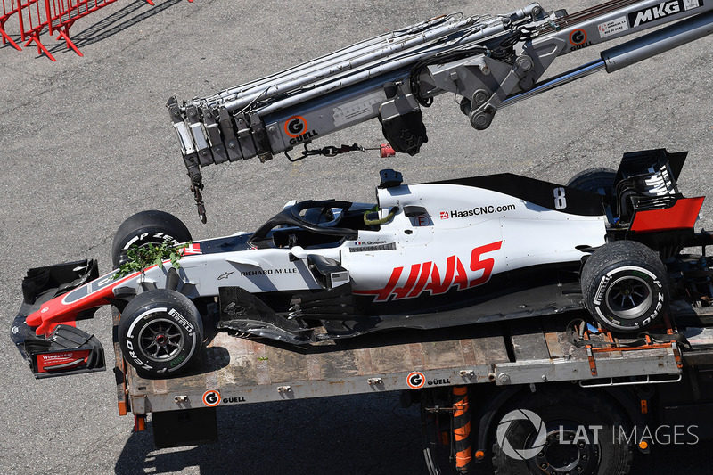 The crashed car of Romain Grosjean, Haas F1 Team VF-18 is recovered to the pits in FP2