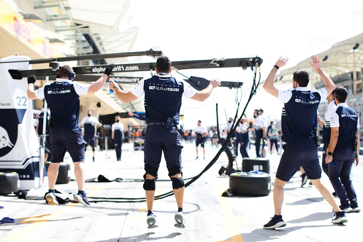 AlphaTauri pit crew perform warm-up exercises in Bahrain. Teams are spending increasing stretches on the road, putting a huge toll on their mental and physical wellbeing 