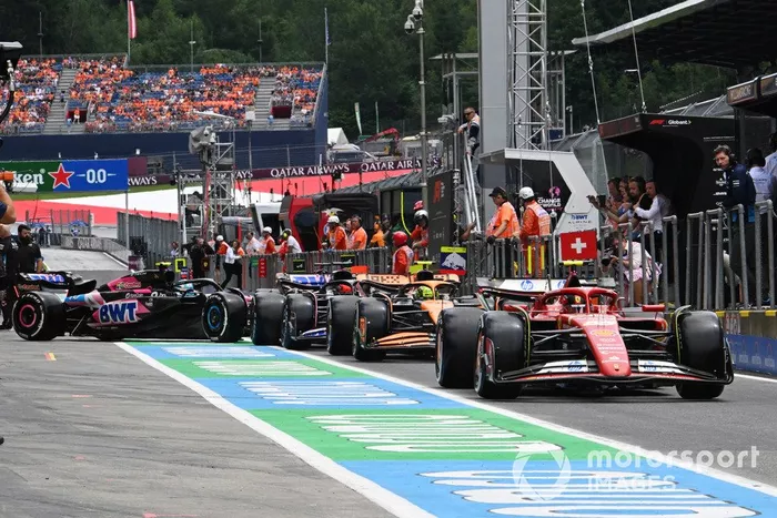 Carlos Sainz, Ferrari SF-24, Lando Norris, McLaren MCL38, Esteban Ocon, Alpine A524, en la cola para salir de boxes.