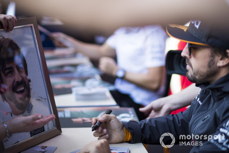 Fernando Alonso, McLaren, signs autographs