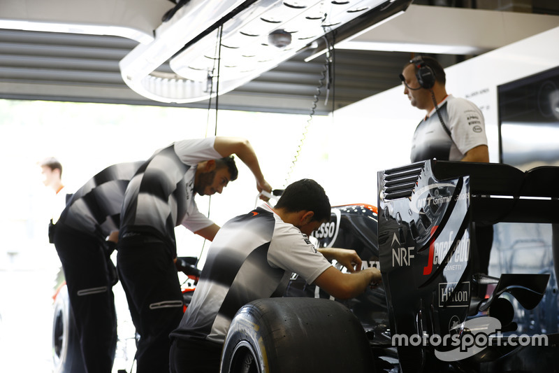 McLaren team members at work in the garage