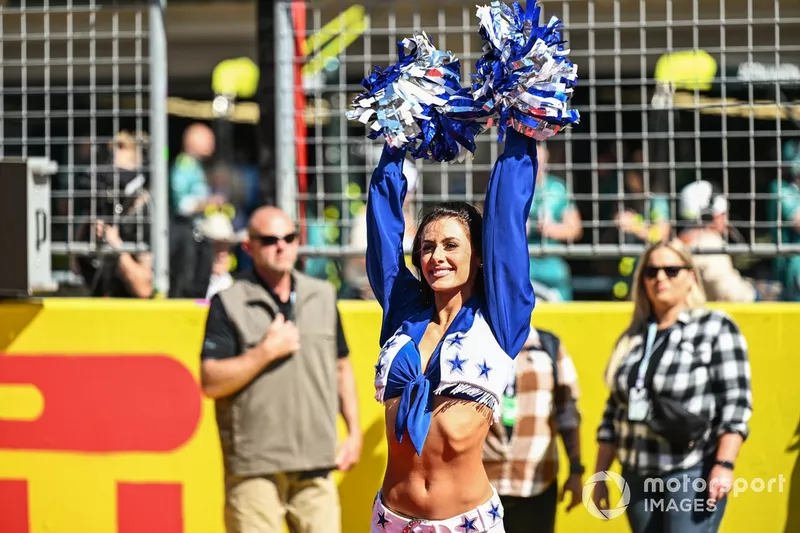 A Dallas Cowboy Cheerleader on the grid for the drivers parade 