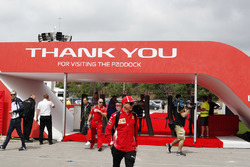Kimi Raikkonen, Ferrari, and Robert Kubica, Williams Martini Racing, arrive in the paddock