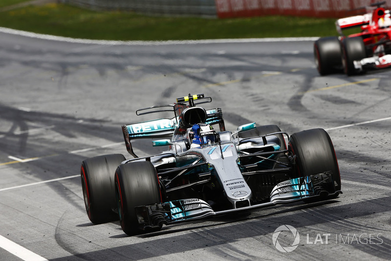 Valtteri Bottas, Mercedes AMG F1 W08, lifts his arm in victory celebration at the finish, ahead of Sebastian Vettel, Ferrari SF70H