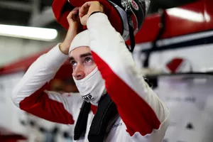 Charles Leclerc, Sauber, puts on his helmet.