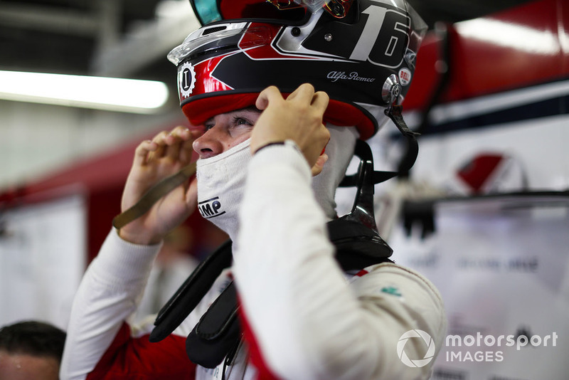 Charles Leclerc, Sauber, puts on his helmet.