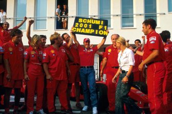 Michael Schumacher celebrates his fourth World Championship with members of the Ferrari team and his wife Corinna