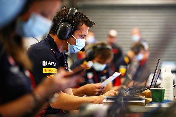 Phil Turner of Red Bull Racing works in the garage