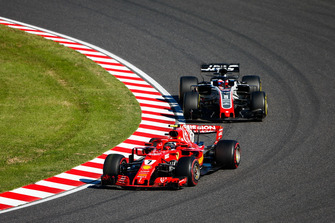 Kimi Raikkonen, Ferrari SF71H, leads Romain Grosjean, Haas F1 Team VF-18
