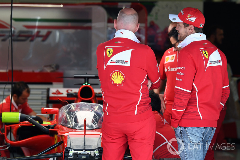 Sebastian Vettel, Ferrari looks at Ferrari SF70H with cockpit shield