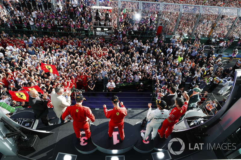 Sebastian Vettel, Ferrari, celebrates victory on the podium with Lewis Hamilton, Mercedes AMG F1, an