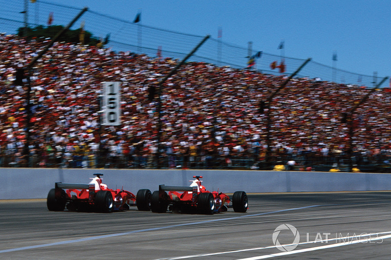 Michael Schumacher, Ferrari F2004 passes team mate Rubens Barrichello, Ferrari F2004