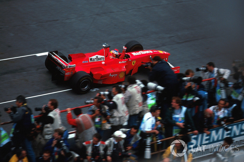 Michael Schumacher, Ferrari F300 crosses the line to win the race