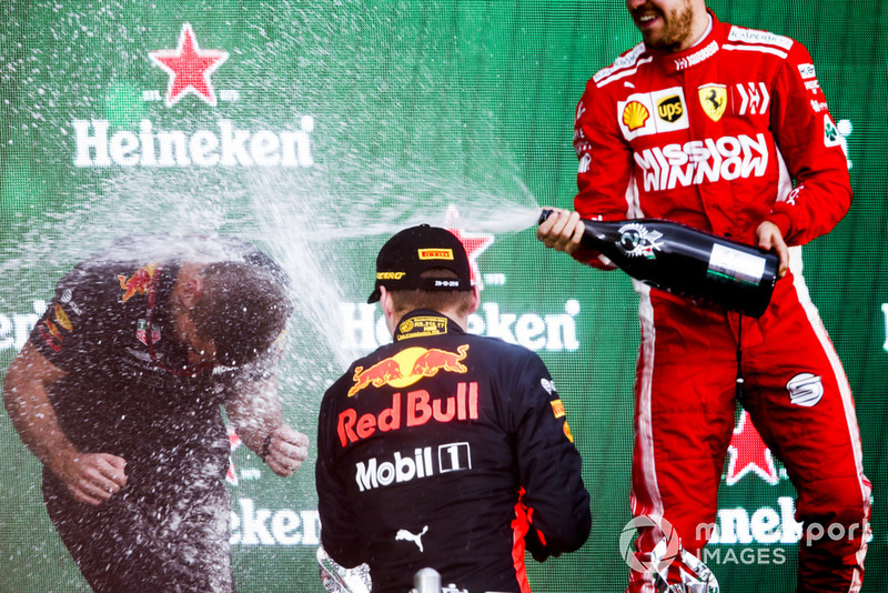 Max Verstappen, Red Bull Racing, 1st position, and Sebastian Vettel, Ferrari, 2nd position, spray Champagne on the podium