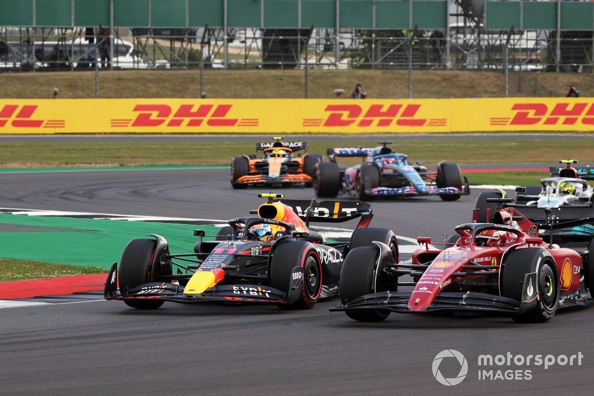 Charles Leclerc, Ferrari F1-75, battles with Sergio Perez, Red Bull Racing RB18