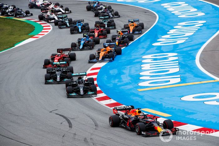 Max Verstappen, Red Bull Racing RB16B, Lewis Hamilton, Mercedes W12, Valtteri Bottas, Mercedes W12, Daniel Ricciardo, McLaren MCL35M, Charles Leclerc, Ferrari SF21, y el resto del pelotón en la primera vuelta