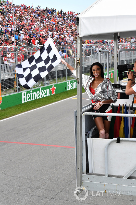 Winnnie Harlow, waves the chequered flag