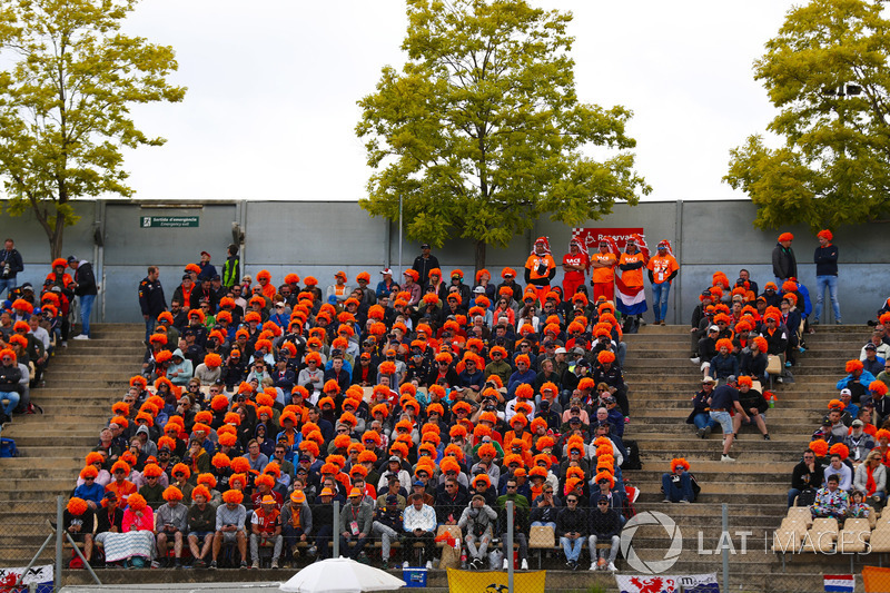 Dutch fans of Max Verstappen, Red Bull Racing RB14, wear orange wigs