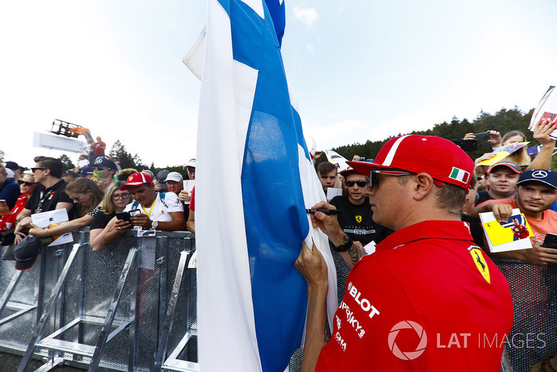 Kimi Raikkonen, Ferrari, signs autographs for fans