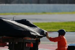 A marshal assists in loading the Jolyon Palmer Renault Sport F1 Team RS17 onto the back of a truck