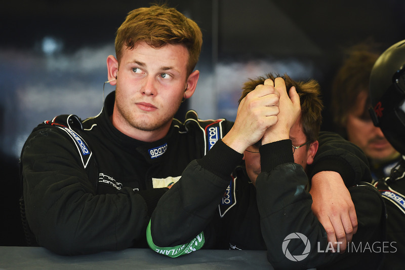 Proton Competition crew members react to their early retirement from the race